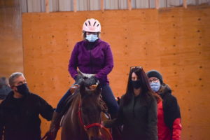 tbtra inside barn with rider
